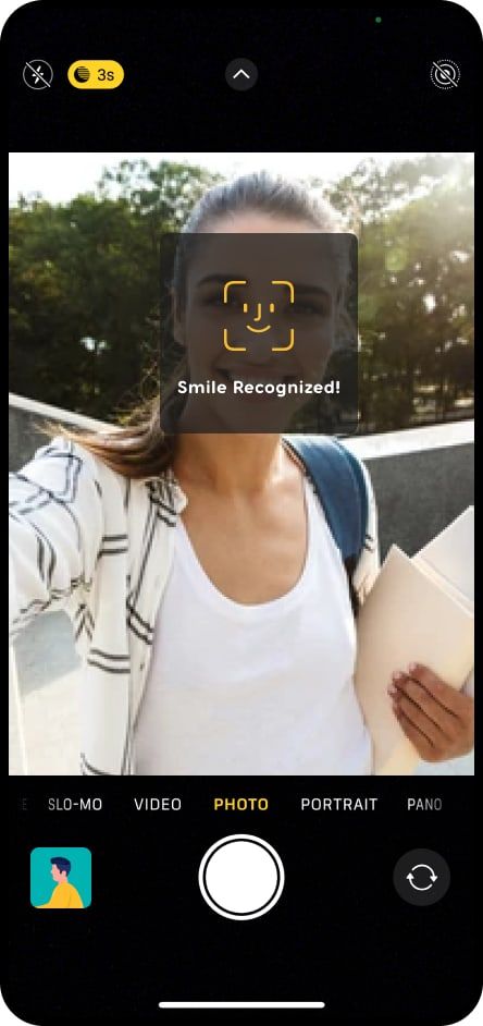 A Zeniversity camera screen with a face detection frame over a smiling person and the message Smile Recognized