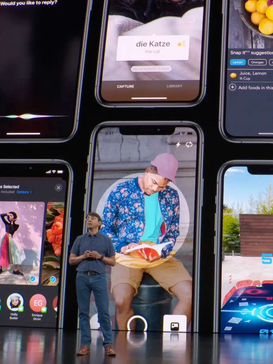 A wall of iPhone screens on the 2019 Apple keynote stage, presenter at left